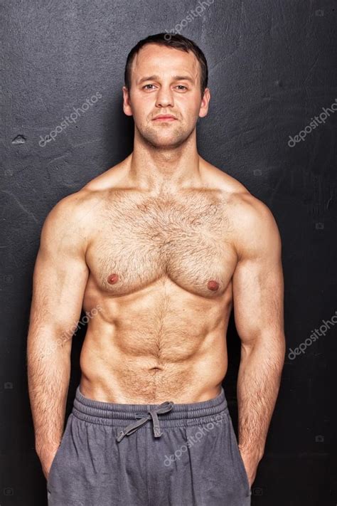 Handsome Man With Naked Torso Posing In Front Of Black Wall Stock Photo Fxquadro