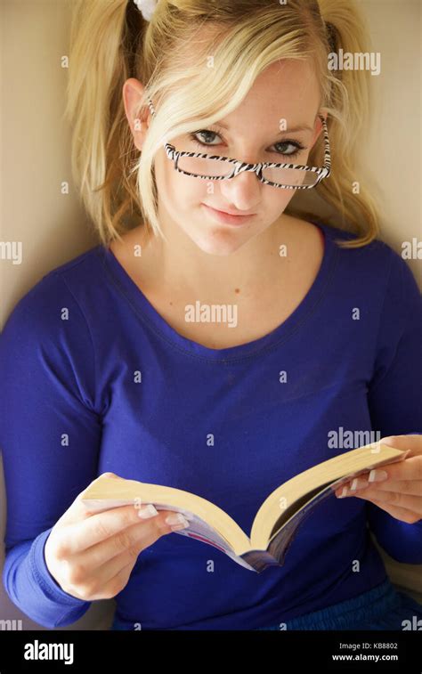 Blonde Girl Posing As A Bookworm Nerd Stock Photo Alamy