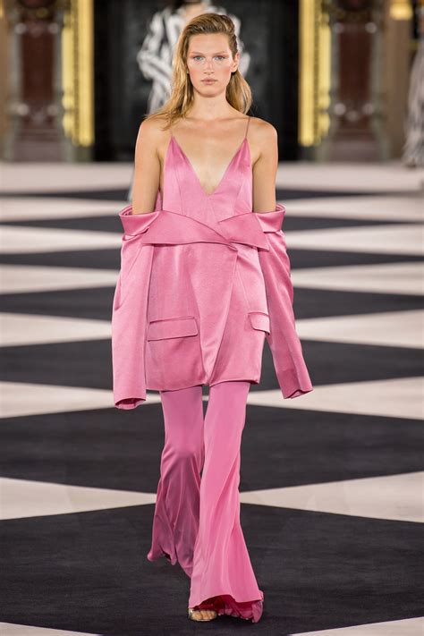 A Model Walks Down The Runway In Pink