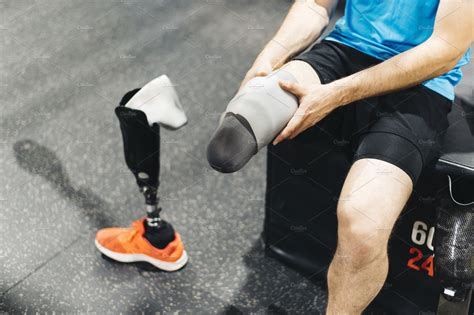Disabled Athlete Assembling His Leg Featuring Active Amputate And