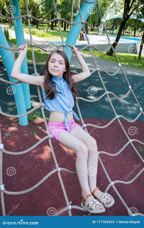 Portrait Of Girl Playing On Playground In Park In Summer Time Summer Vacation Stock Image