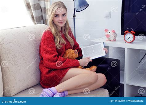 Happy Caucasian Teen Girl Resting On Sofa At The Living Room While