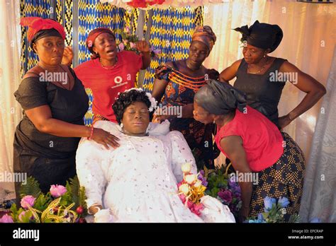 Friends And Relatives Gathered Around The Deceased In A Traditional
