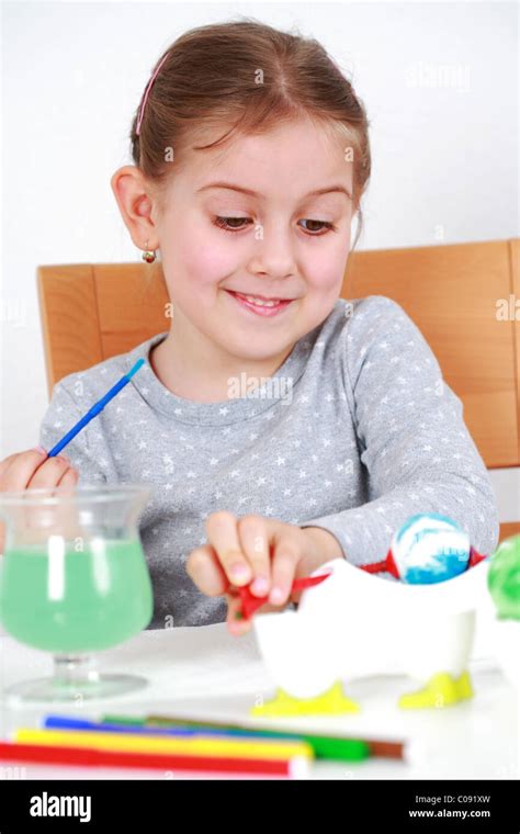 Cute Little Girl Painting Easter Eggs Stock Photo Alamy