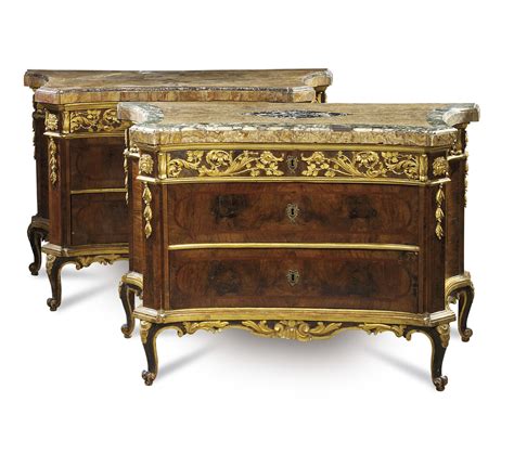 A Pair Of North Italian Parcel Gilt Walnut And Amaranth Commodes
