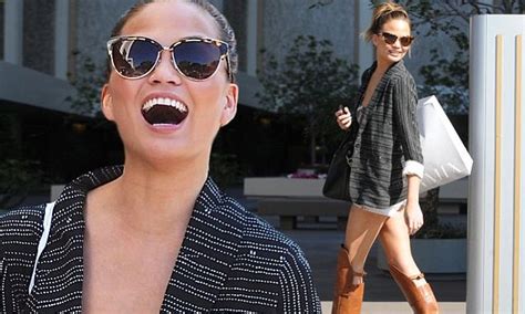 Chrissy Teigen Turns Heads In Tan Over The Knee Boots And White Shorts