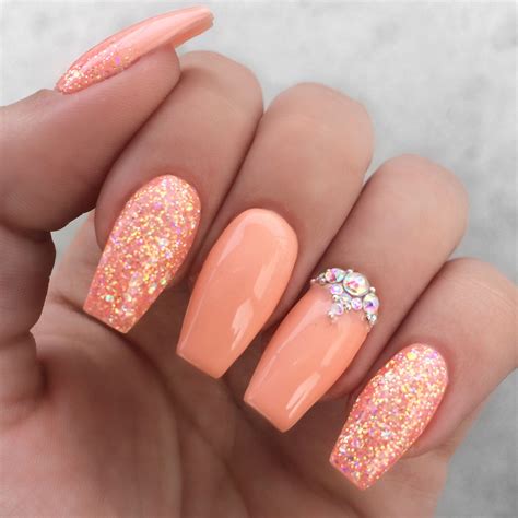 Although this peach color is fading, these nails are definitely not! Girly peach glitter rhinestone nails | Peach acrylic nails ...