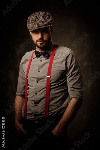 Serious Old Fashioned Man In Tweed Hat Wearing Suspenders And Bow Tie