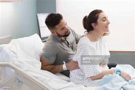 Man Easing Back Pain Of Pregnant Wife Photo Getty Images