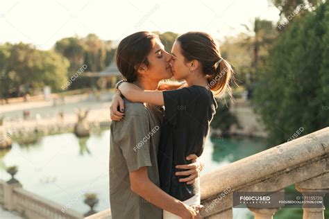 Portrait Of Boyfriend Embracing Girlfriend And Kissing In Nose On