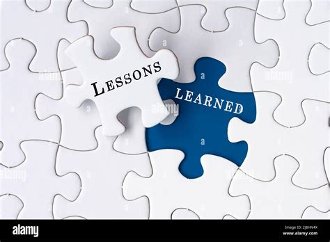 Lessons Learned Text On Jigsaw Puzzle Over Blue Background Stock Photo