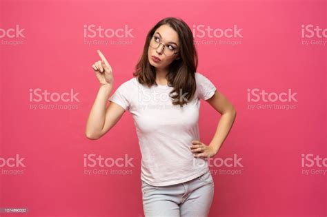 Photo Of Happy Young Woman Standing Isolated Over Pink Background
