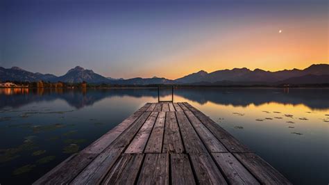 1366x768 Lake Pier And Mountain Sunset 1366x768 Resolution Wallpaper