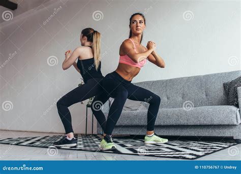 Two Fit Women Doing Squats At Home Female Workout Sport And Fitness Stock Image Image Of