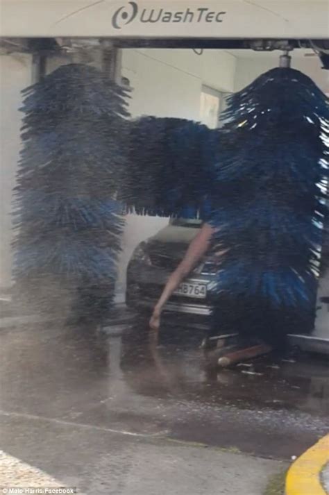 Naked Man Lying On His Vehicle While Inside Of A Drive Through Car Wash