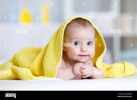 Funny Baby Under Soft Towel Cute Child Lying On Bed After Bathing In