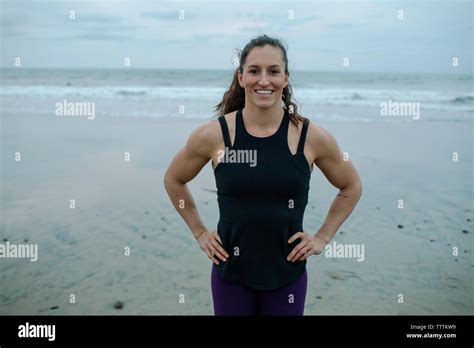Portrait Of Confident Muscular Build Woman With Hands On Hip Exercising