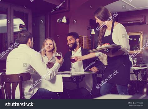 Friendly Smiling Young Waitress Serving Meal Stock Photo 607998392