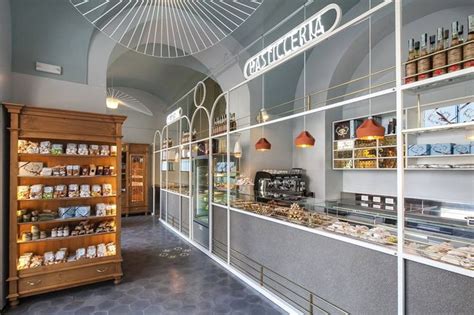 The Inside Of A Bakery With Lots Of Food On Display In Glass Cases And