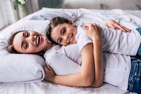 The Attractive Daughter And A Mother Laying On The Bed Stock Image