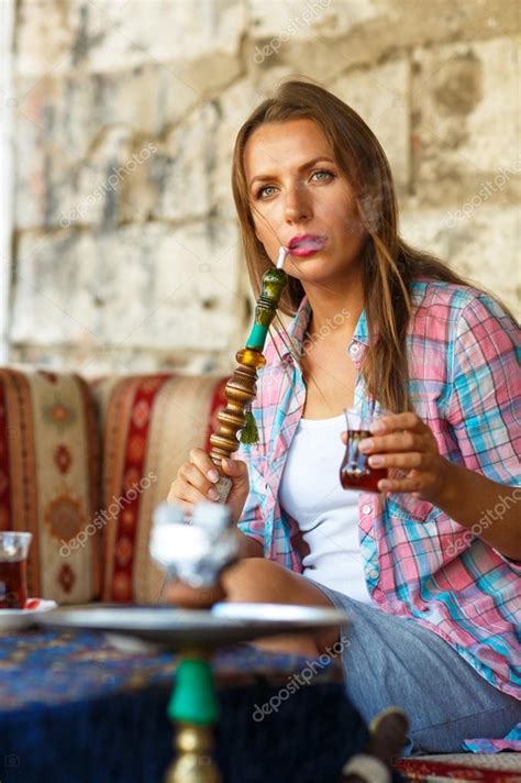 Woman Smoking A Hookah And Drinking Tea In A Cafe Istanbul Tur