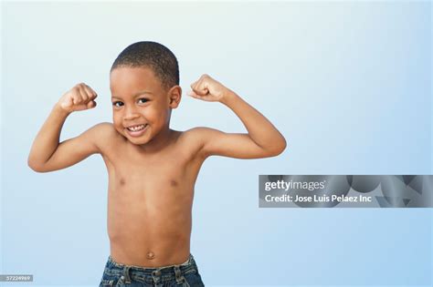 African American Boy Flexing Muscles High Res Stock Photo Getty Images