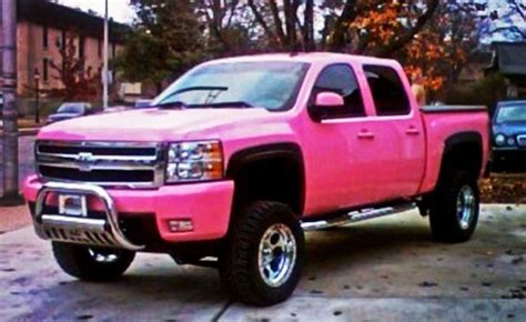 A Pink Pick Up Truck Parked In A Parking Lot