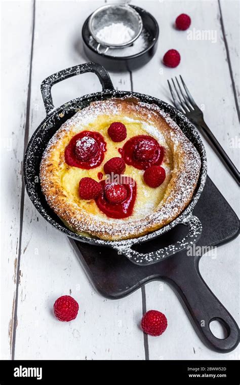 Dutch Baby Pancake With Raspberries And Powdered Sugar Stock Photo Alamy