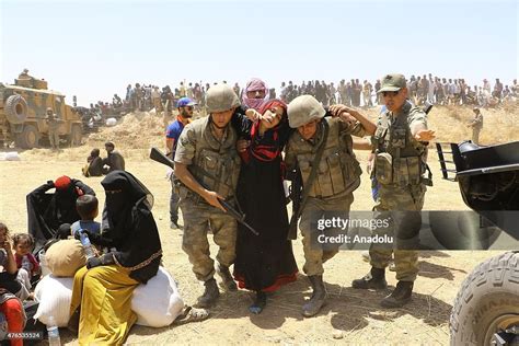 Turkish Soldiers Help A Syrian Woman To Cross Into Turkey From The