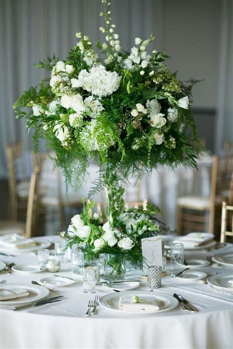 Decorating the tables for your wedding reception is an important part of the wedding planning. Reception - centerpiece - white flowers - greenery ...