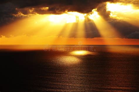 Golden Sunlight Through Dark Clouds Over Ocean Stock Photo Image Of
