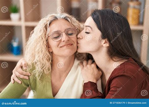 Two Women Mother And Daughter Hugging Each Other And Kissing At Home Stock Image Image Of