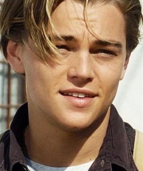 A Close Up Of A Person Wearing A Shirt And Tie With His Hair In The Wind