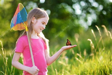Little Girl Catching Butterflies — Stock Photo © Mnstudio 131908644