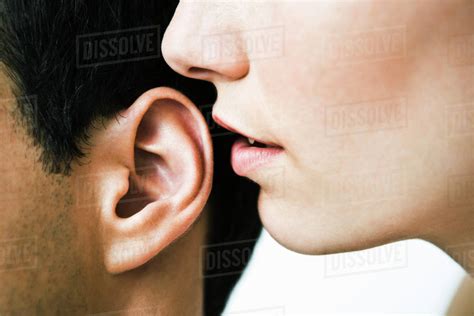 Woman Whispering In Man S Ear Close Up Stock Photo Dissolve