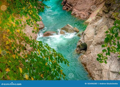 The Mountain River Flows Through The Gorge Turquoise Water Stock Photo