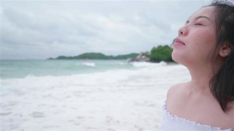 Asian Short Hair Woman Takes Deep Breath On A Beach 2015224 Stock Video