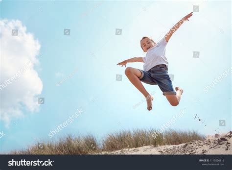 Boy Leaping Jumping Over Sand Dune Stock Photo 1115536316 Shutterstock