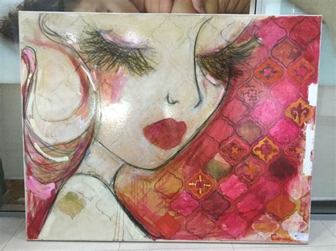 a woman's face is painted on a canvas with pink and red colors,