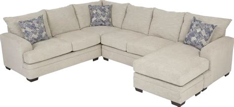 A Large Sectional Couch With Pillows On The Top And Bottom Corner In
