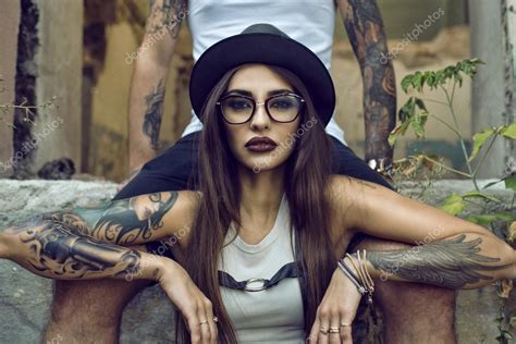 Gorgeous Tattooed Girl With Provocative Make Up Sitting Between Her