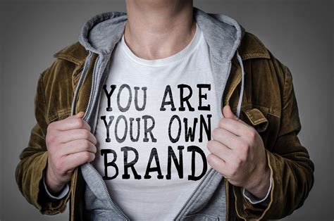 A Man Wearing A T Shirt With The Words You Are Your Own Brand On It