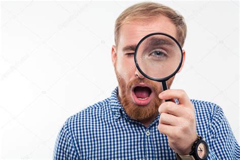 Man Looking Through Magnifying Glass At Camera Stock Photo By