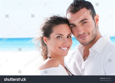Smiling Happy Couple Looking At Camera Together At Summer Beach Stock