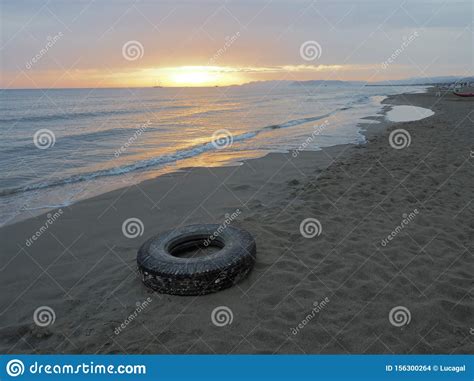 Ocean Plastic Pollution Old Truck Tyre Tire On The Beach Stock Photo