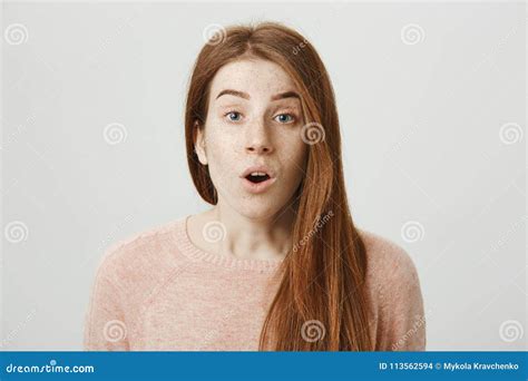 close up portrait of beautiful redhead caucasian woman expressing shock or surprise looking