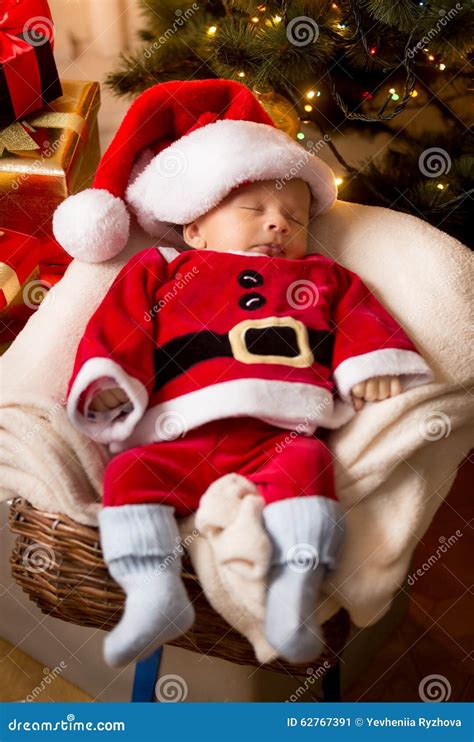 Newborn Baby Boy In Santa Claus Costume Sleeping In Basket Stock Image