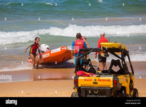 Australian Surf Rescue Volunteers With Zodiac Inflatable And Beach Buggy Transport On North Curl