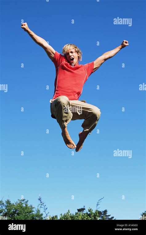 Young Man Jumping Stock Photo Alamy