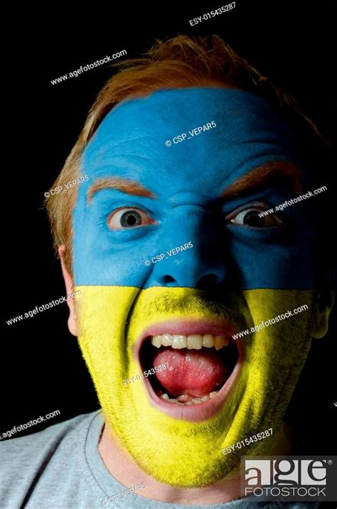 Face Of Crazy Angry Man Painted In Colors Of Ukraine Flag Stock Photo